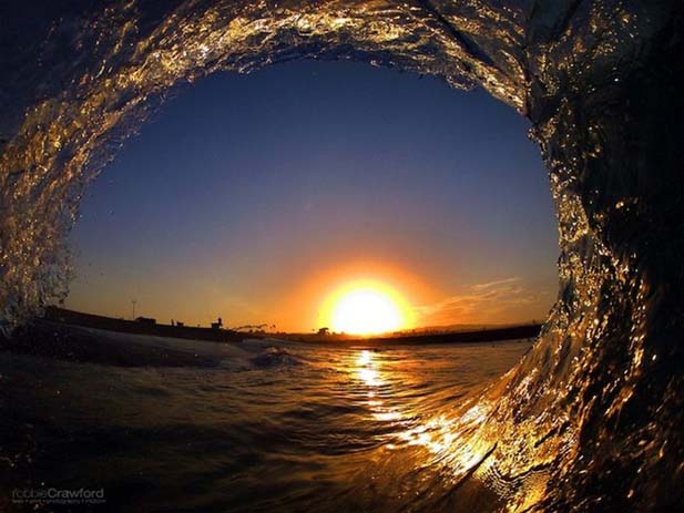 Curling wave over sunset at Huntington Beach, California. Photo by Robbie Crawford