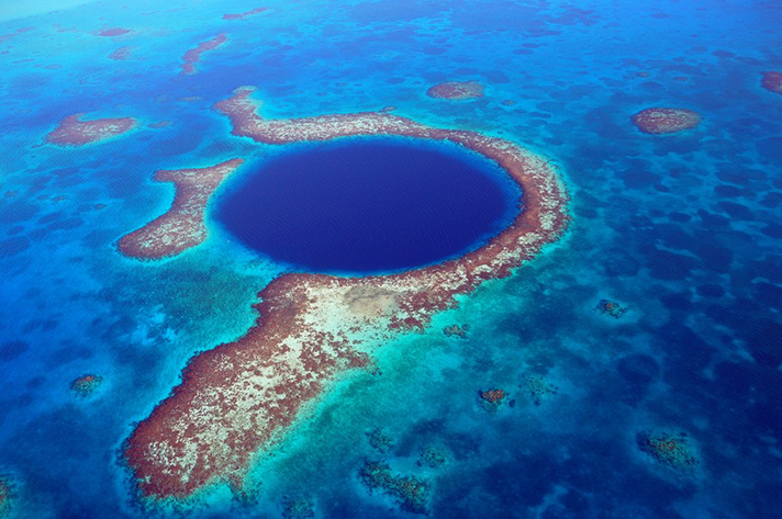 Incredible places to dive around the world: Belize Blue hole from the air. Photo by Andrew Hounslea, flickr