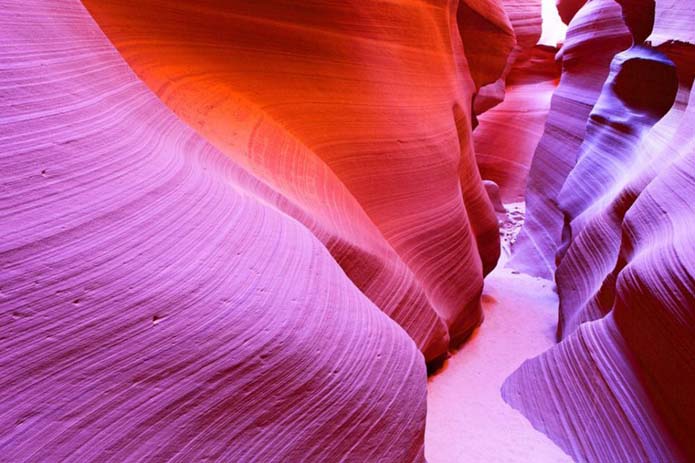 Less light reaches the caves and crevices of Antelope Canyon. Image via Distractify,