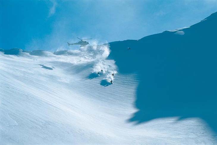 Skiing off of a helicopter in New Zealand. Photo via vacationidea